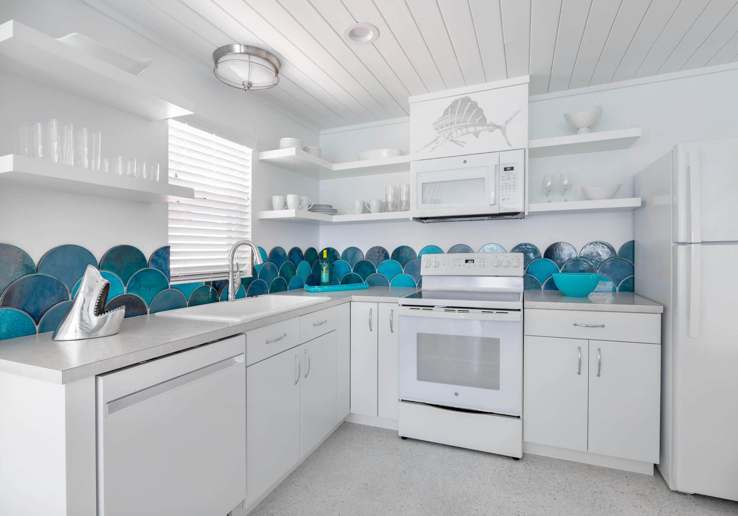 white kitchen with ocean blue tiles accent orange moon interiors
